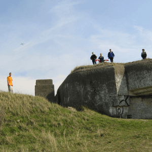 Tom & Becky Dean's 4 children standing on top of a WW2 German concrete bunkers in the Netherlands, part of the Atlantic Wall.