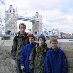 photo of Tom & Becky Dean's children standing in front of the Tower Bridge in London.
