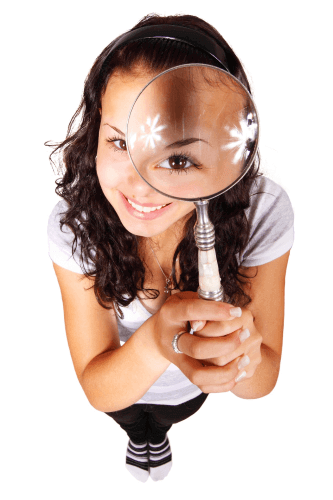 young woman holding a magnifying glass looking up