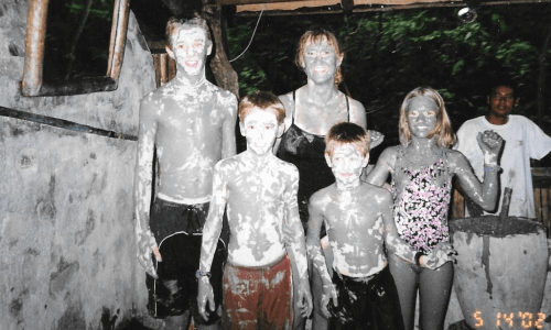 photo of Becky Dean with her 4 children covered in mud on an Usborne Books at Home trip to Costa Rica.